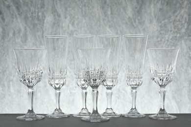 Photo of Many empty clean glasses on grey table