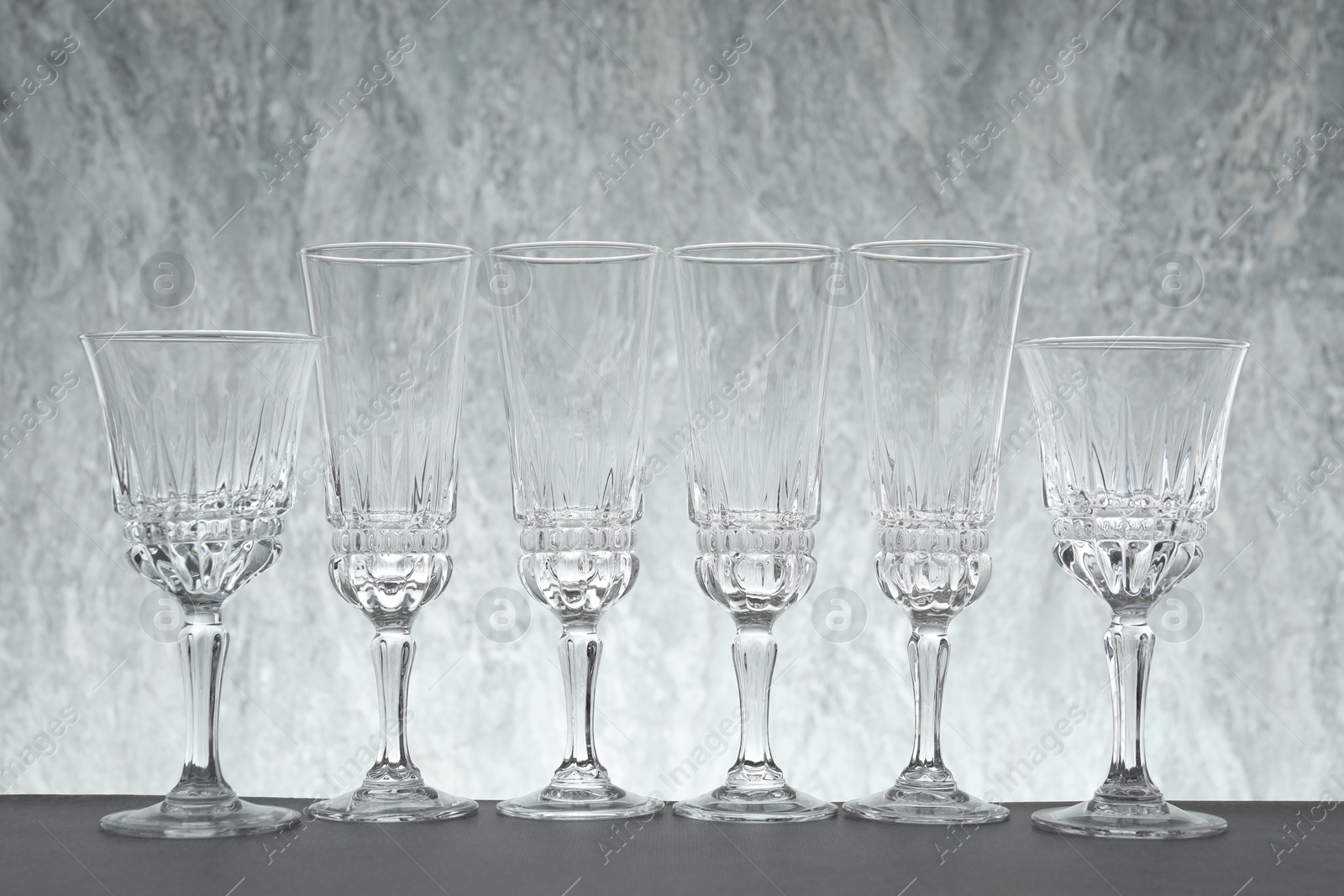 Photo of Many empty clean glasses on grey table