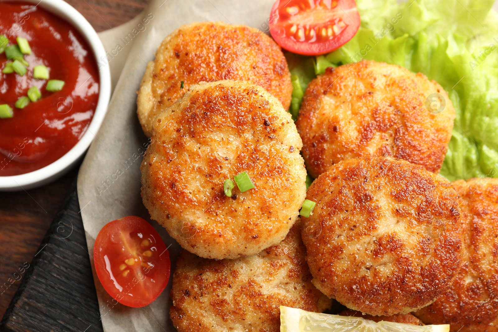 Photo of Delicious patties served on wooden table, top view