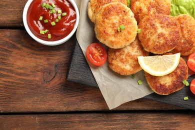 Photo of Delicious patties served on wooden table, top view. Space for text