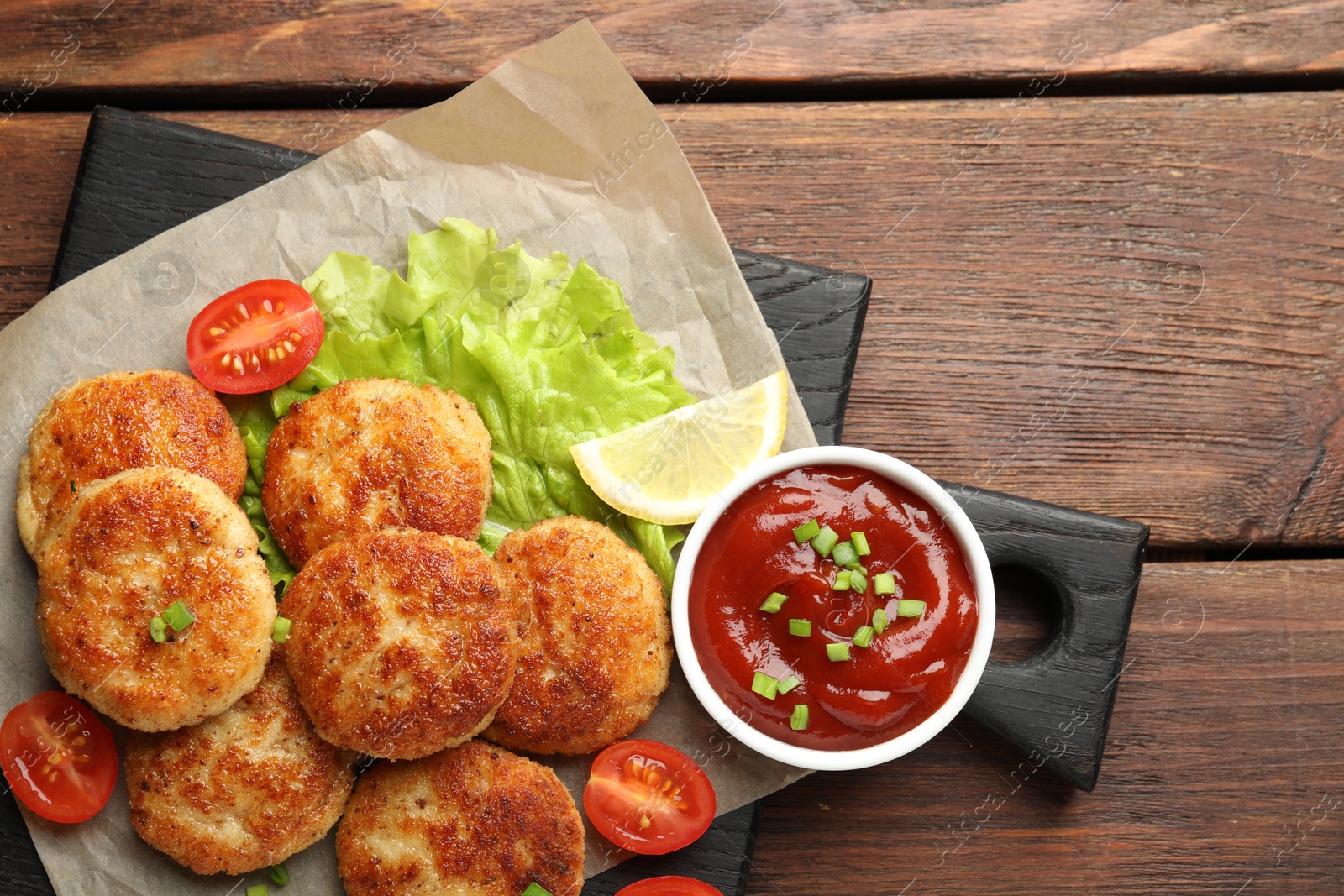 Photo of Delicious patties served on wooden table, top view