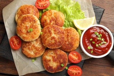 Photo of Delicious patties served on wooden table, top view