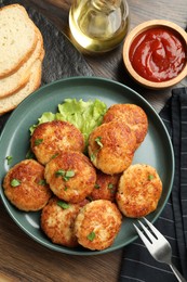 Photo of Delicious patties served on wooden table, flat lay