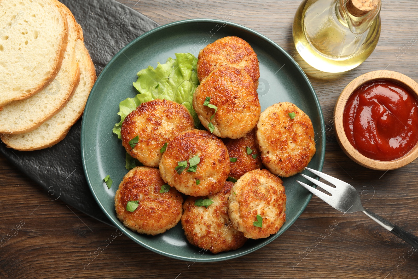 Photo of Delicious patties served on wooden table, flat lay