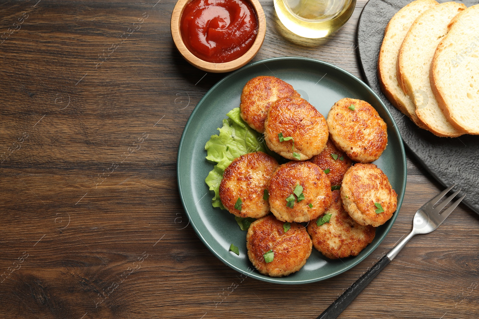 Photo of Delicious patties served on wooden table, flat lay. Space for text