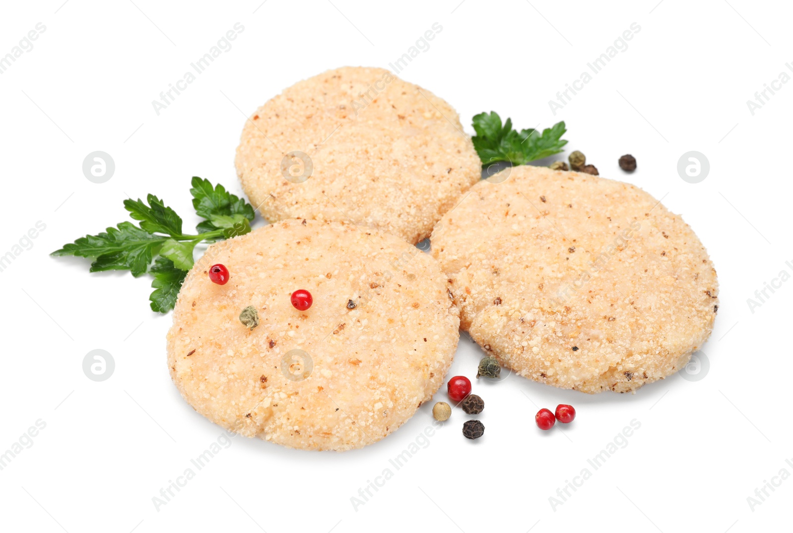 Photo of Uncooked patties and spices isolated on white