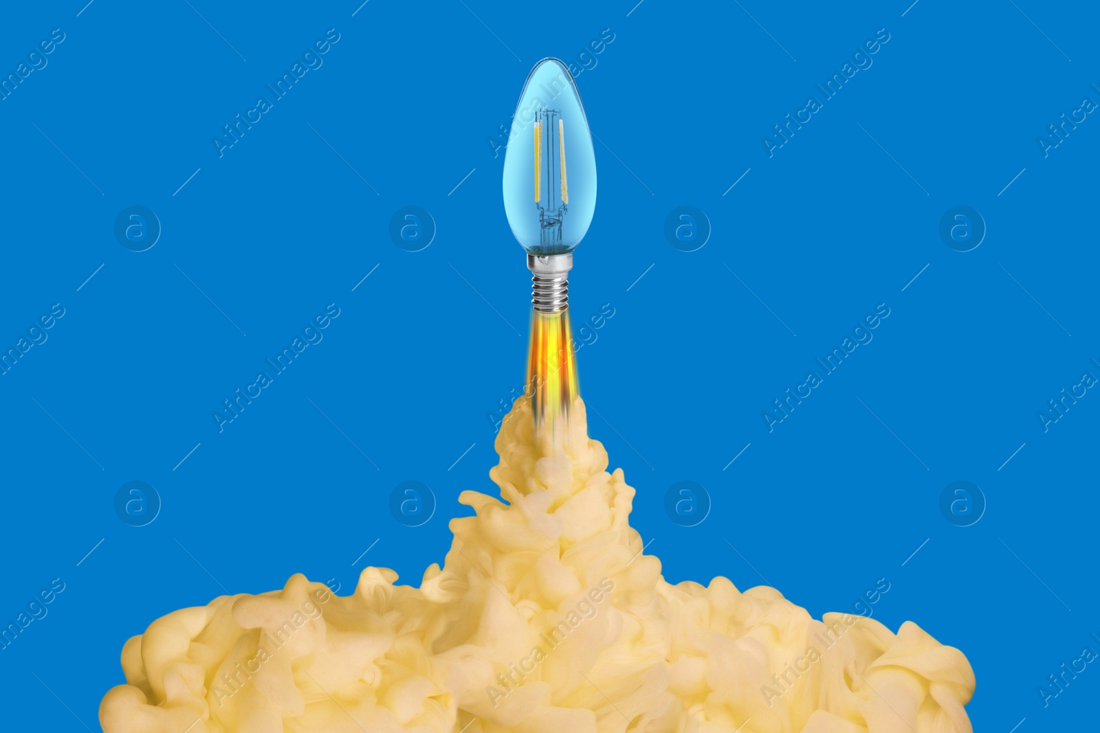 Image of Light bulb soaring up like rocket with smoke and fire on blue background. Concepts of idea, startup, creativity, fast success