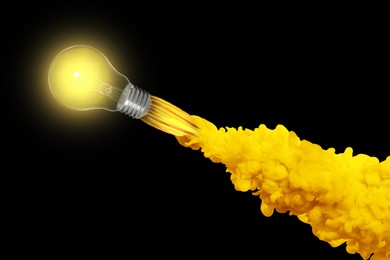 Image of Glowing light bulb flying like rocket with smoke and fire on black background. Concepts of idea, startup, creativity, fast success