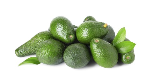 Photo of Pile of whole ripe avocados with green leaves isolated on white