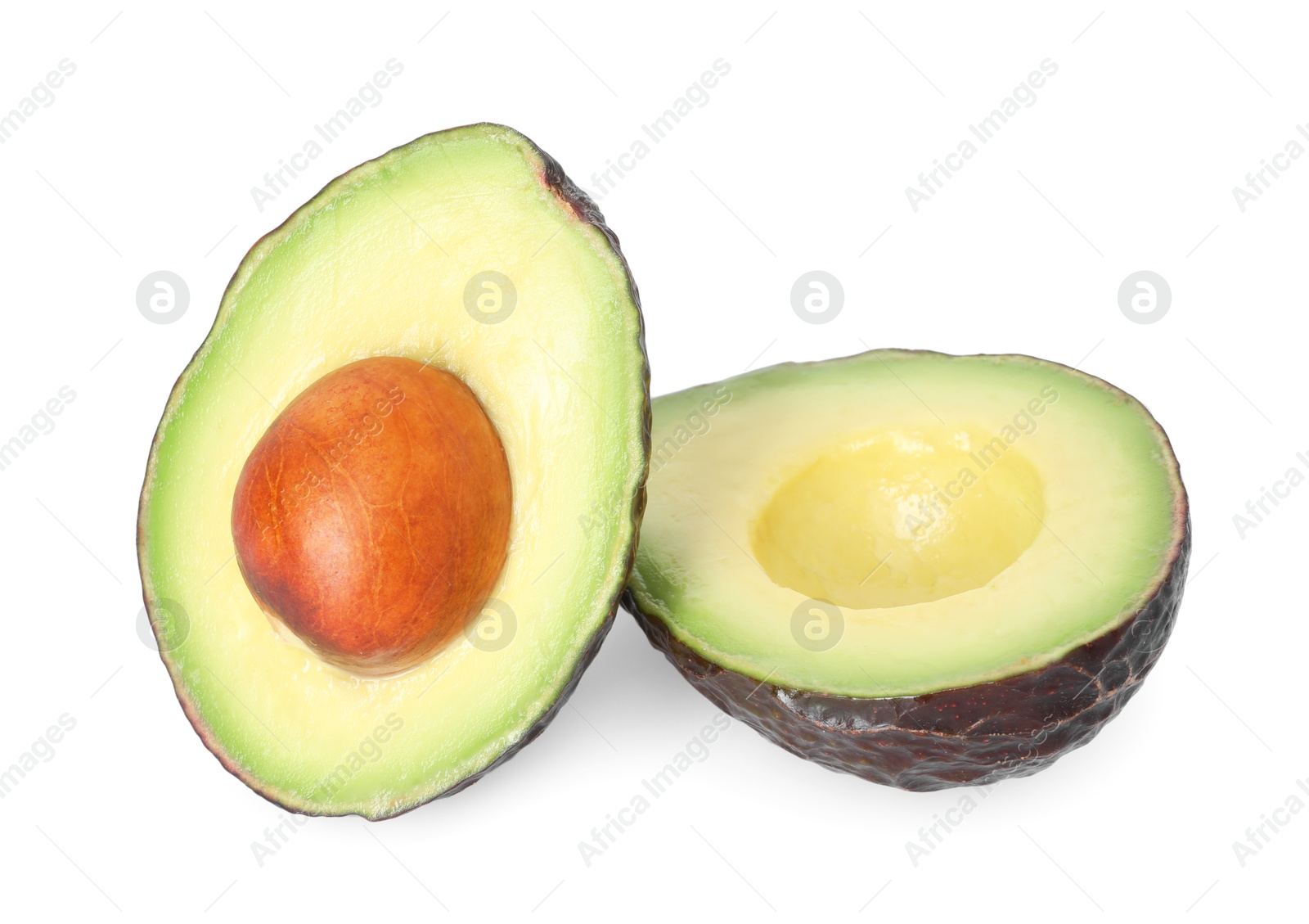 Photo of Halves of ripe avocado isolated on white