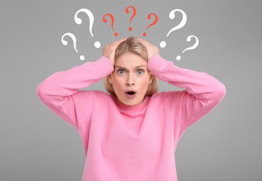 Image of Question marks over shocked woman on grey background