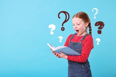 Image of Little girl surprised with information in book on light blue background, space for text. Question marks around child