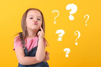 Image of Cute little girl near question marks on orange background