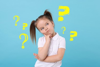 Image of Confused little girl on light blue background. Yellow question marks near child