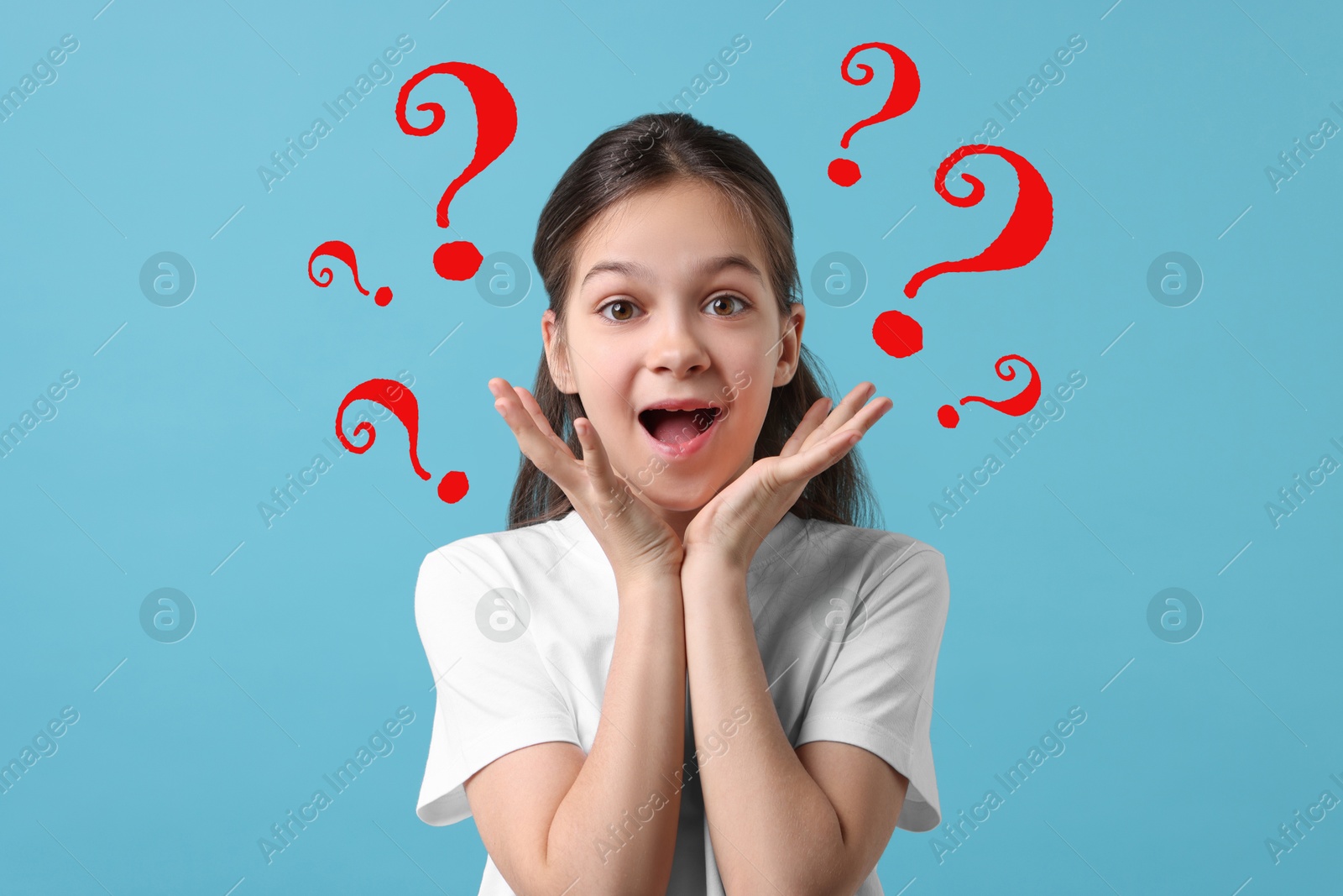 Image of Surprised girl on light blue background. Red question marks around child