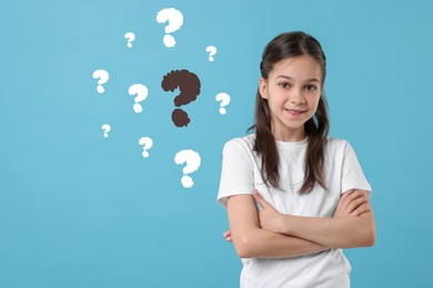 Image of Cute girl on light blue background. Question marks near child