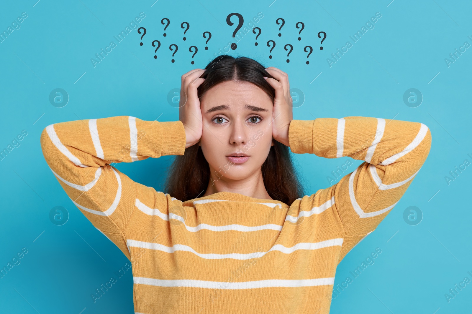 Image of Confused girl on light blue background. Black question marks near her