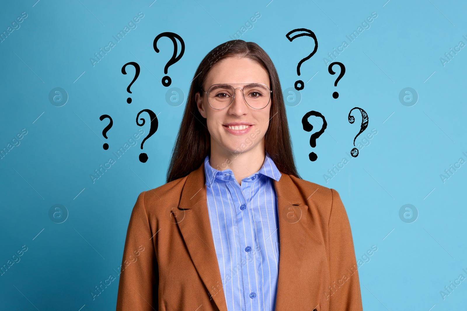 Image of Happy woman surrounded by question marks on light blue background