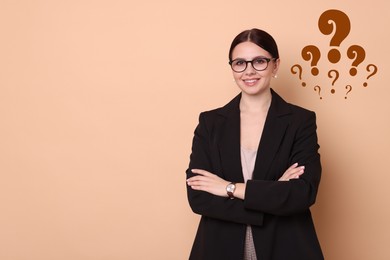 Image of Happy woman on dark beige background, space for text. Question marks near her