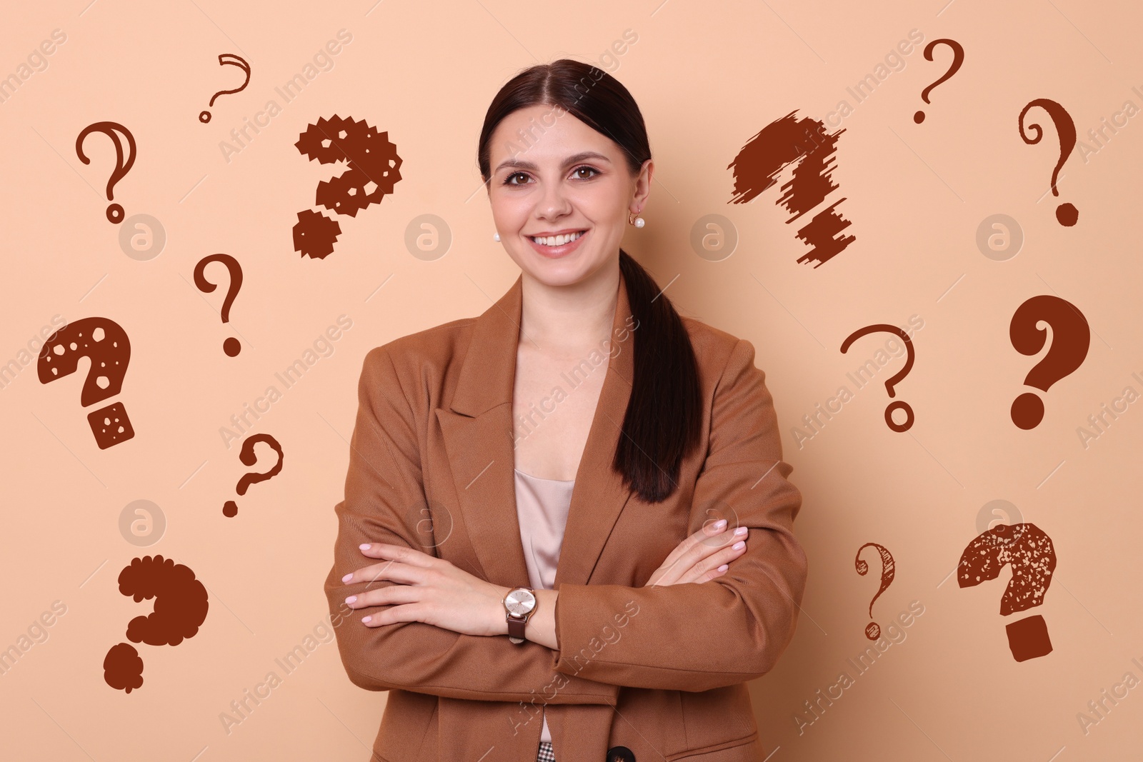 Image of Happy woman on dark beige background. Question marks around her