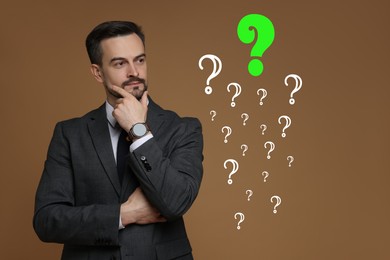 Image of Thoughtful businessman looking at question marks on brown background