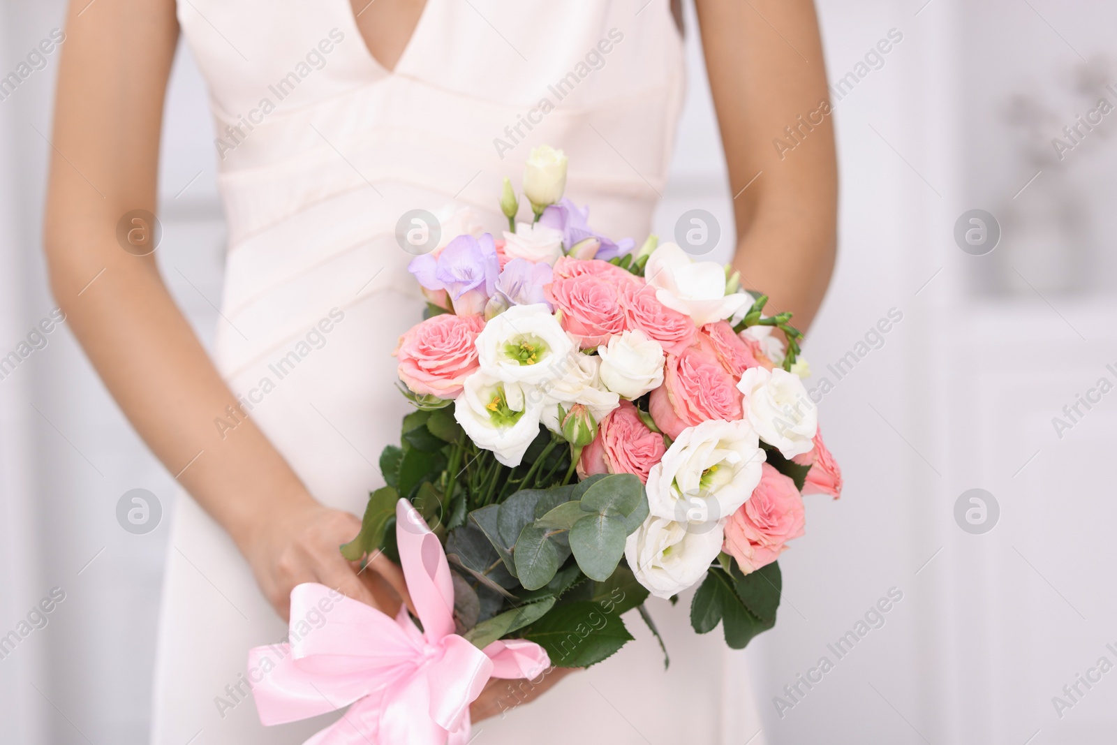 Photo of Bride with beautiful wedding bouquet indoors, closeup