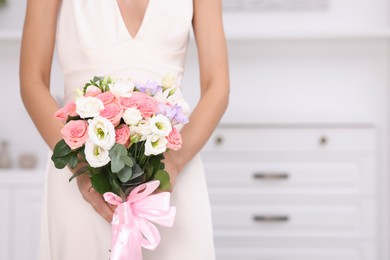 Photo of Bride with beautiful wedding bouquet indoors, closeup. Space for text