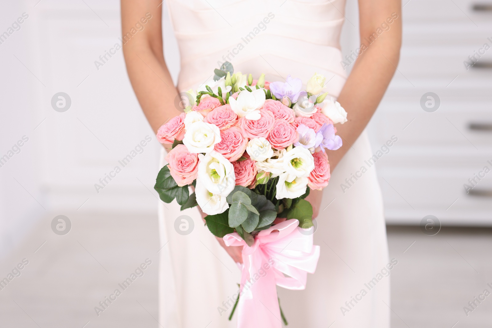 Photo of Bride with beautiful wedding bouquet indoors, closeup