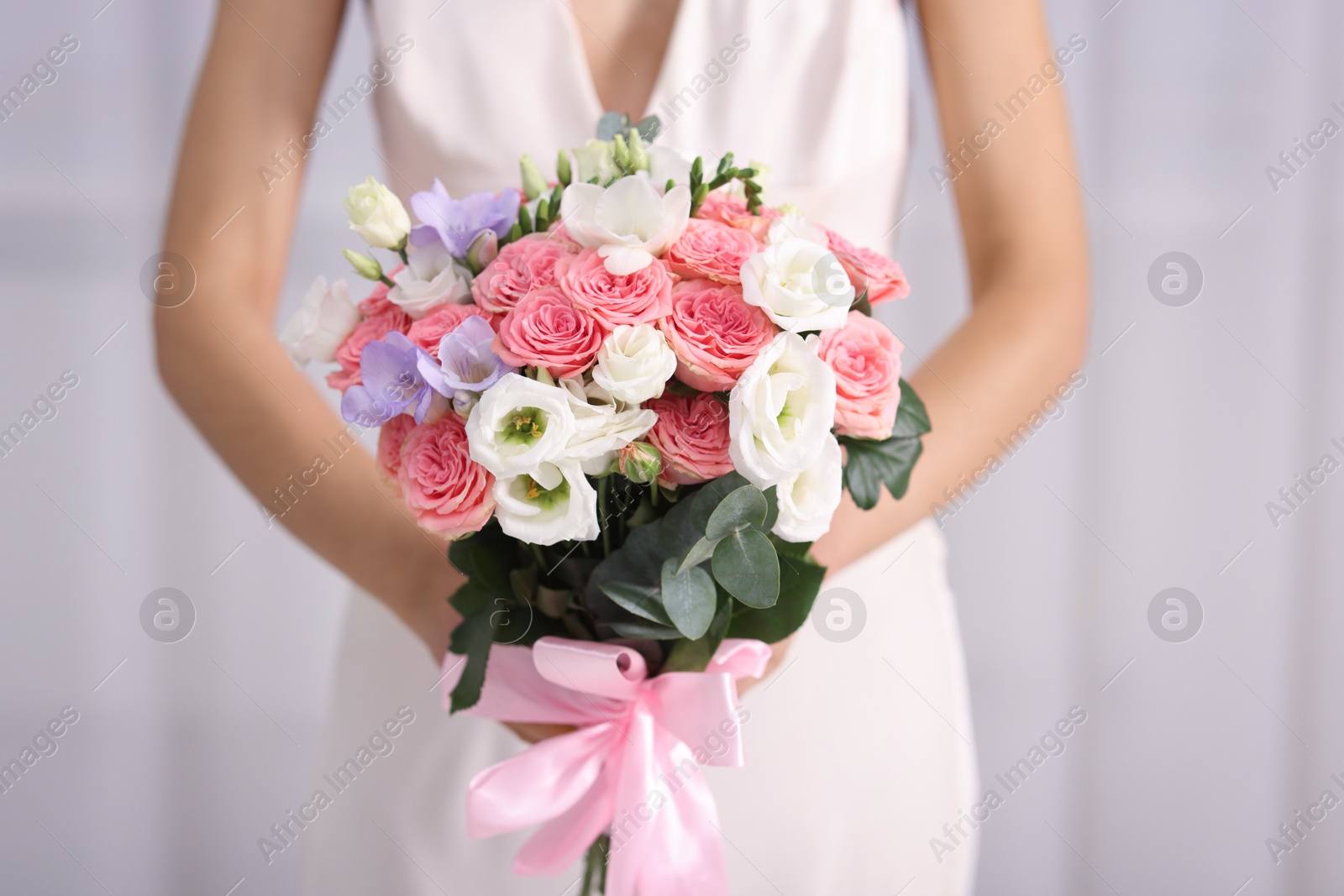 Photo of Bride with beautiful wedding bouquet on light background, closeup