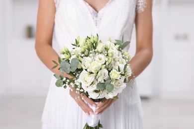 Photo of Bride with beautiful wedding bouquet on light background, closeup