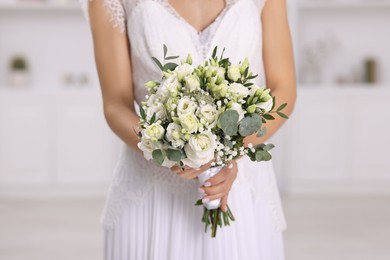 Photo of Bride with beautiful wedding bouquet on light background, closeup