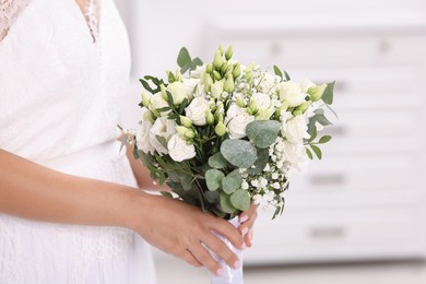 Photo of Bride with beautiful wedding bouquet on light background, closeup