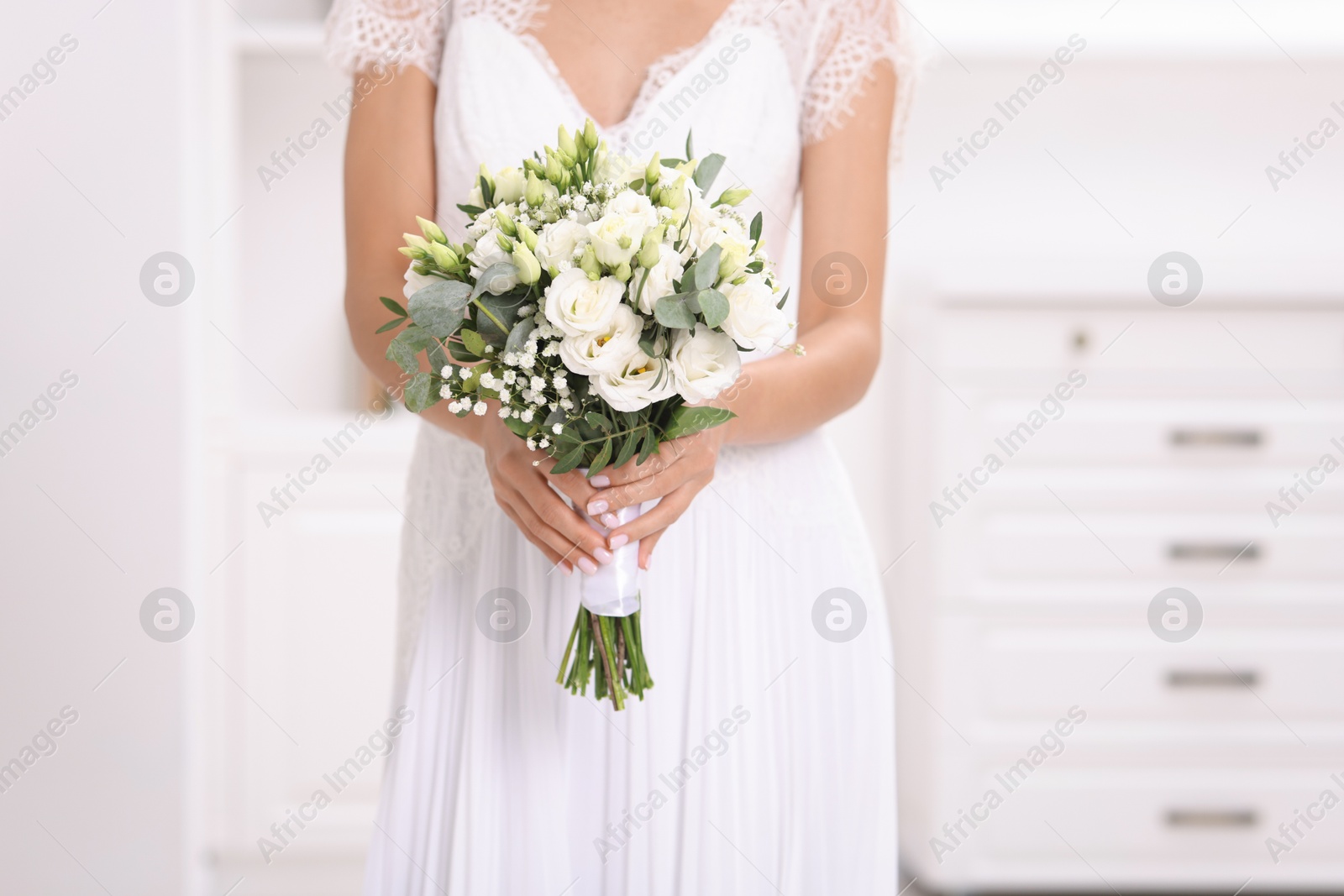 Photo of Bride with beautiful wedding bouquet on light background, closeup