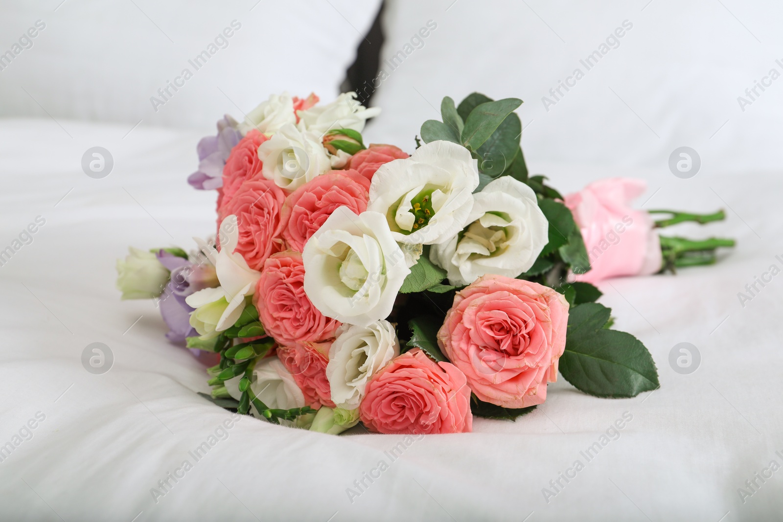 Photo of Wedding bouquet of beautiful flowers on bed, closeup