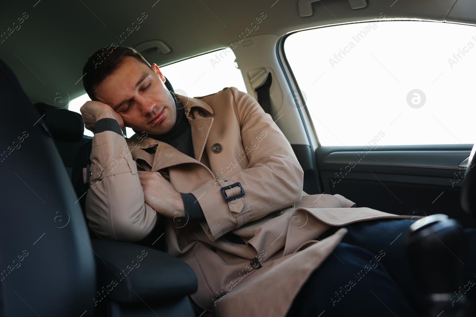 Photo of Tired driver sleeping in his modern car