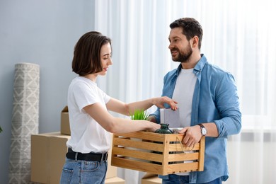 Photo of Moving day. Happy couple unpacking in their new home