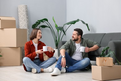 Photo of Moving day. Happy couple with coffee in their new home