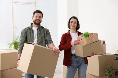 Photo of Moving day. Happy couple with their belongings in new home