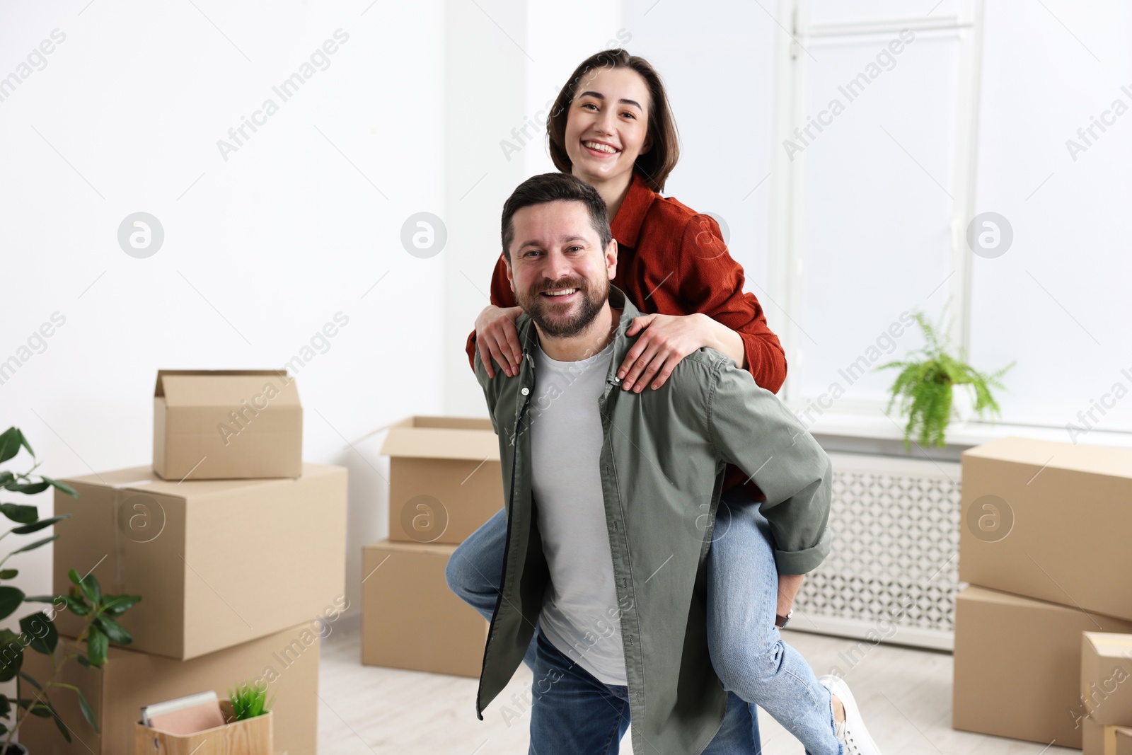 Photo of Moving day. Happy couple having fun in their new home