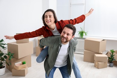 Photo of Moving day. Happy couple having fun in their new home