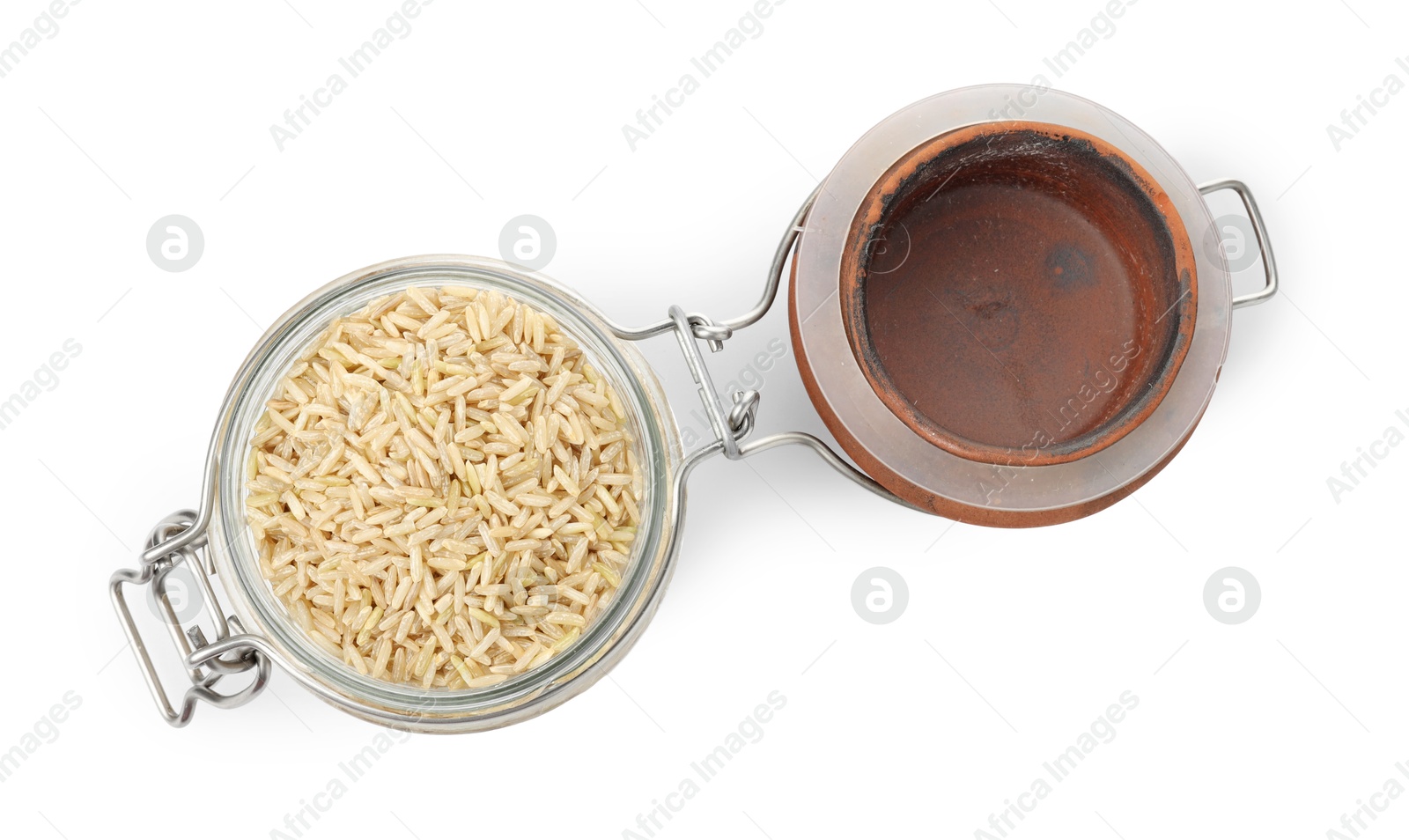 Photo of Raw brown rice in open jar isolated on white, top view