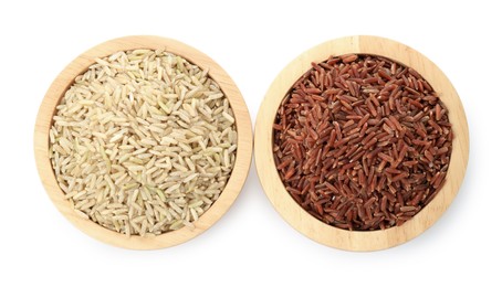 Photo of Different sorts of raw brown rice isolated on white, top view