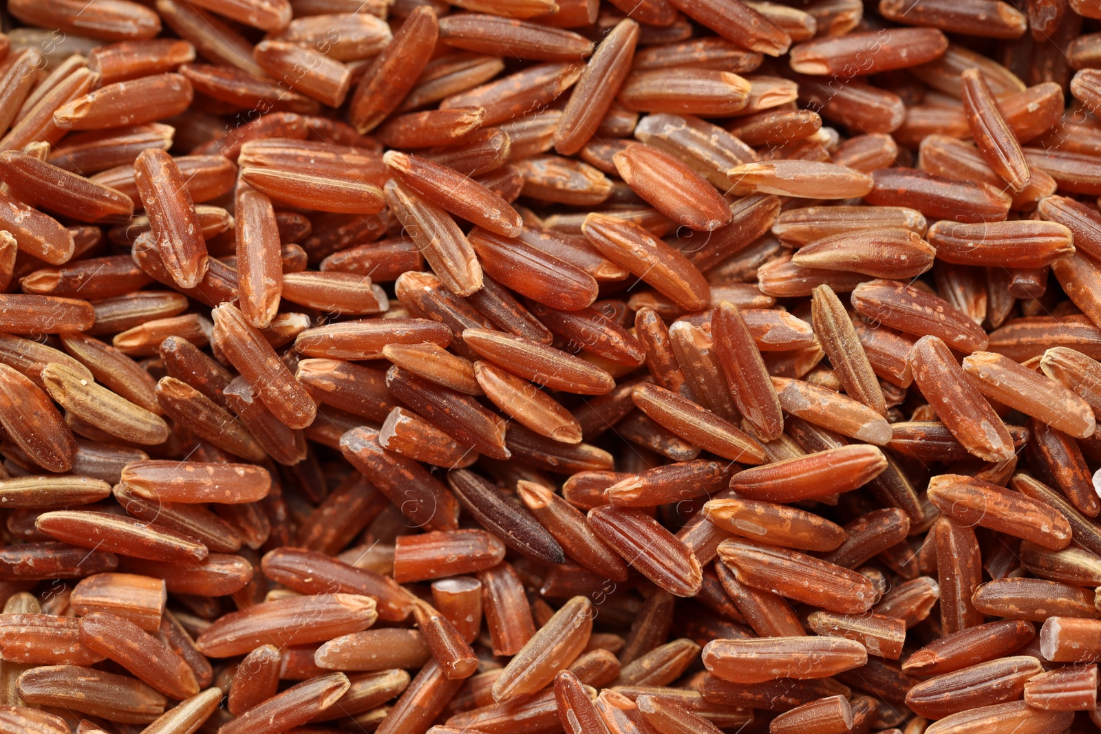 Photo of Pile of brown rice as background, top view