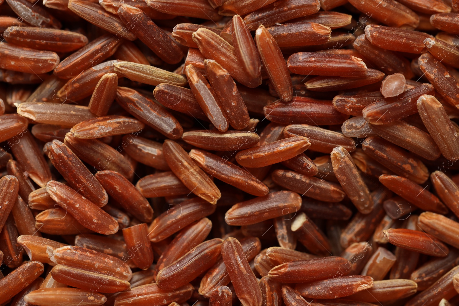 Photo of Pile of brown rice as background, top view