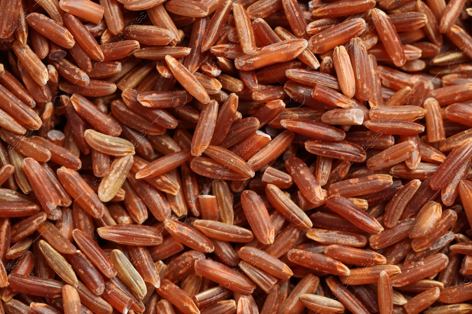 Photo of Pile of brown rice as background, top view