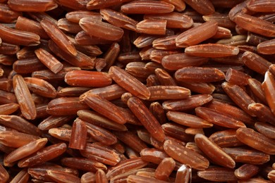 Photo of Pile of brown rice as background, top view