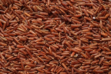 Photo of Pile of brown rice as background, top view