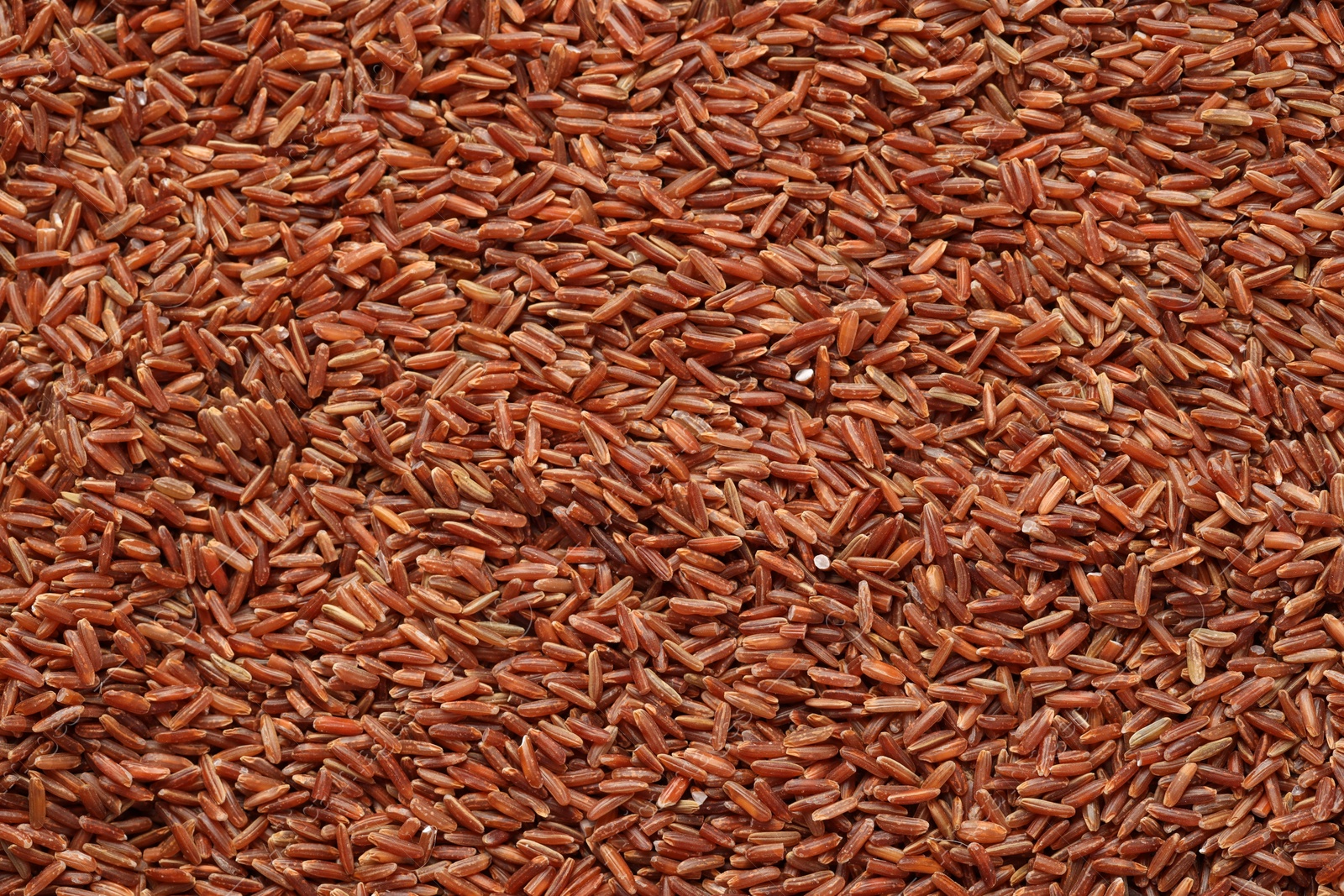 Photo of Pile of brown rice as background, top view