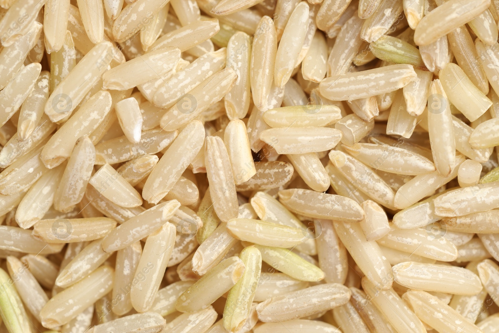 Photo of Pile of brown rice as background, top view