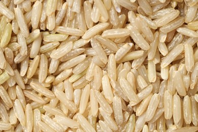 Photo of Pile of brown rice as background, top view